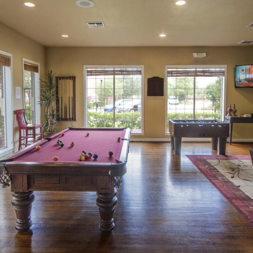 Take advantage of all Heritage at Hooper Hill Apartments has to offer a room with a pool table and chairs