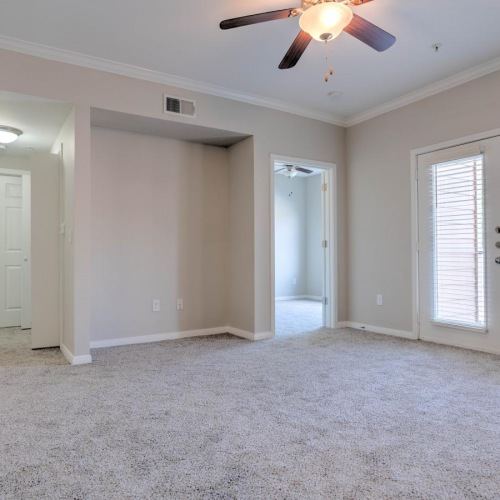 Generous living spaces to relax and unwind a room with a carpet and a ceiling fan