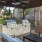 a patio with chairs and grills