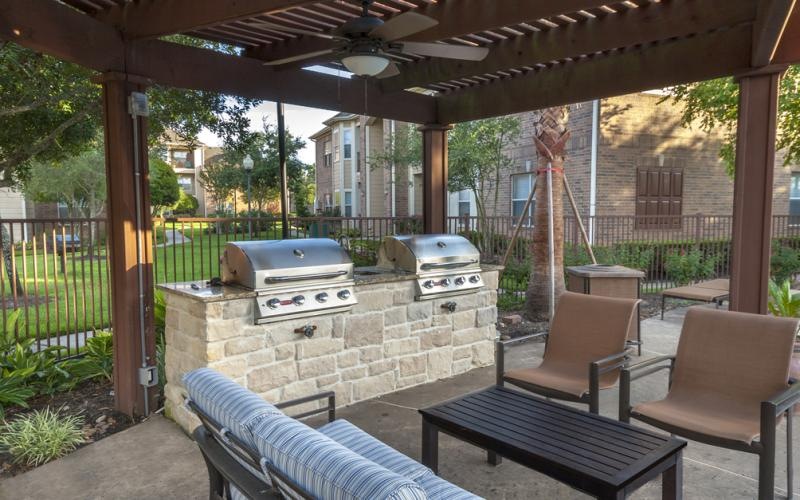 a patio with chairs and grills